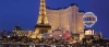a group of people in front of a tall building with Paris Las Vegas in the background