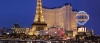 a group of people in front of a tall building with Paris Las Vegas in the background