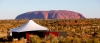 a tent with Uluru in the background