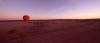 a person with a sunset in the desert