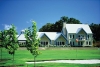 a house on top of a lush green field