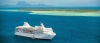 a blue and white boat floating on a body of water