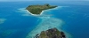 a rocky island in the middle of a body of water