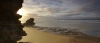 a group of people on a beach near a body of water